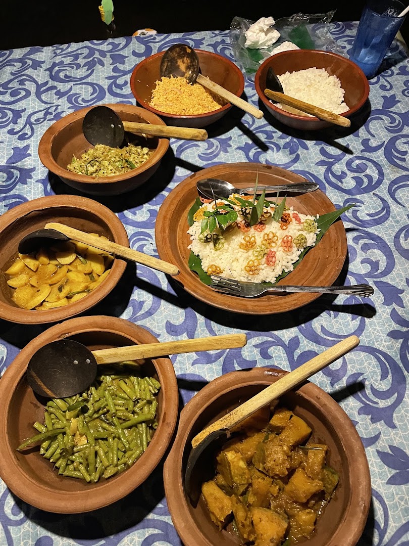 Sri Lankan curries, rice, and vegetables served in clay bowls
